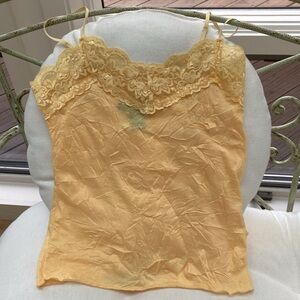 Beautiful buttercup yellow lace top with adjustable straps and lace neckline.